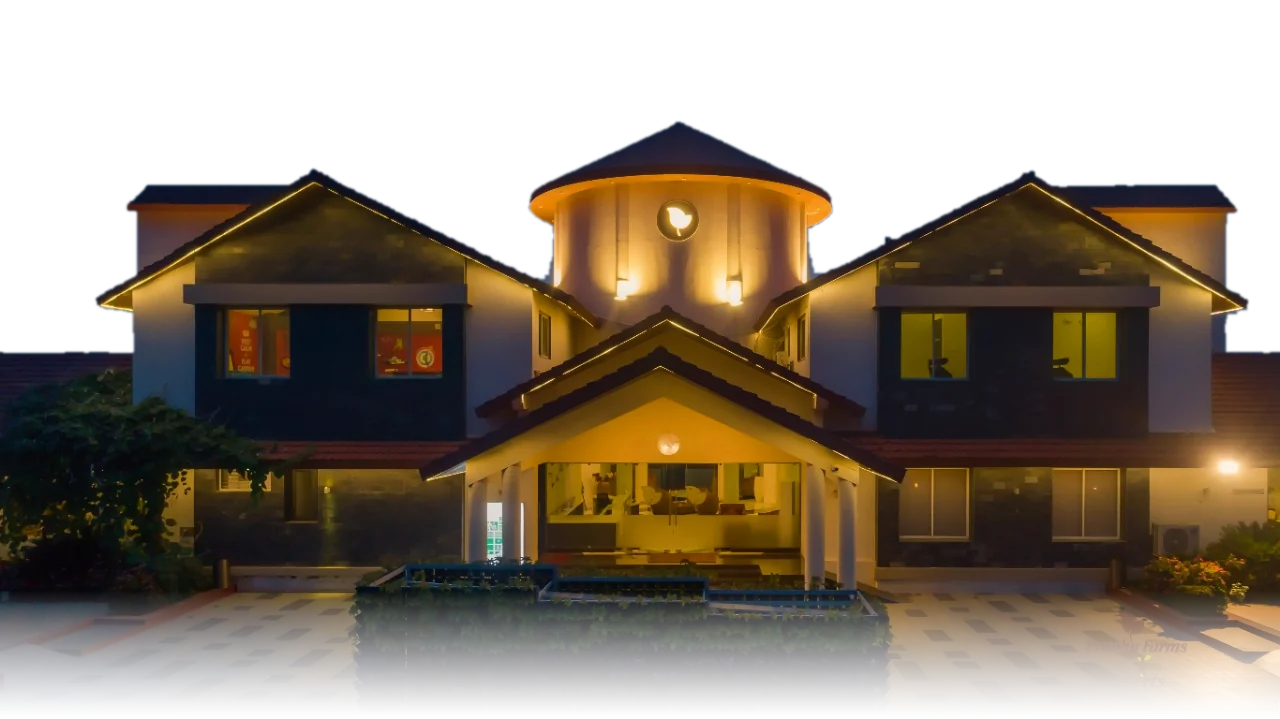 Prabhu Resorts in Rajkot, lit up at dusk